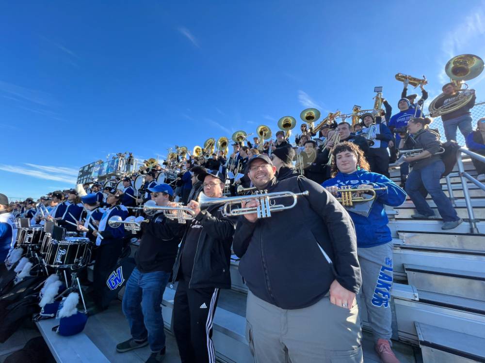 trumpet alumni in the stands